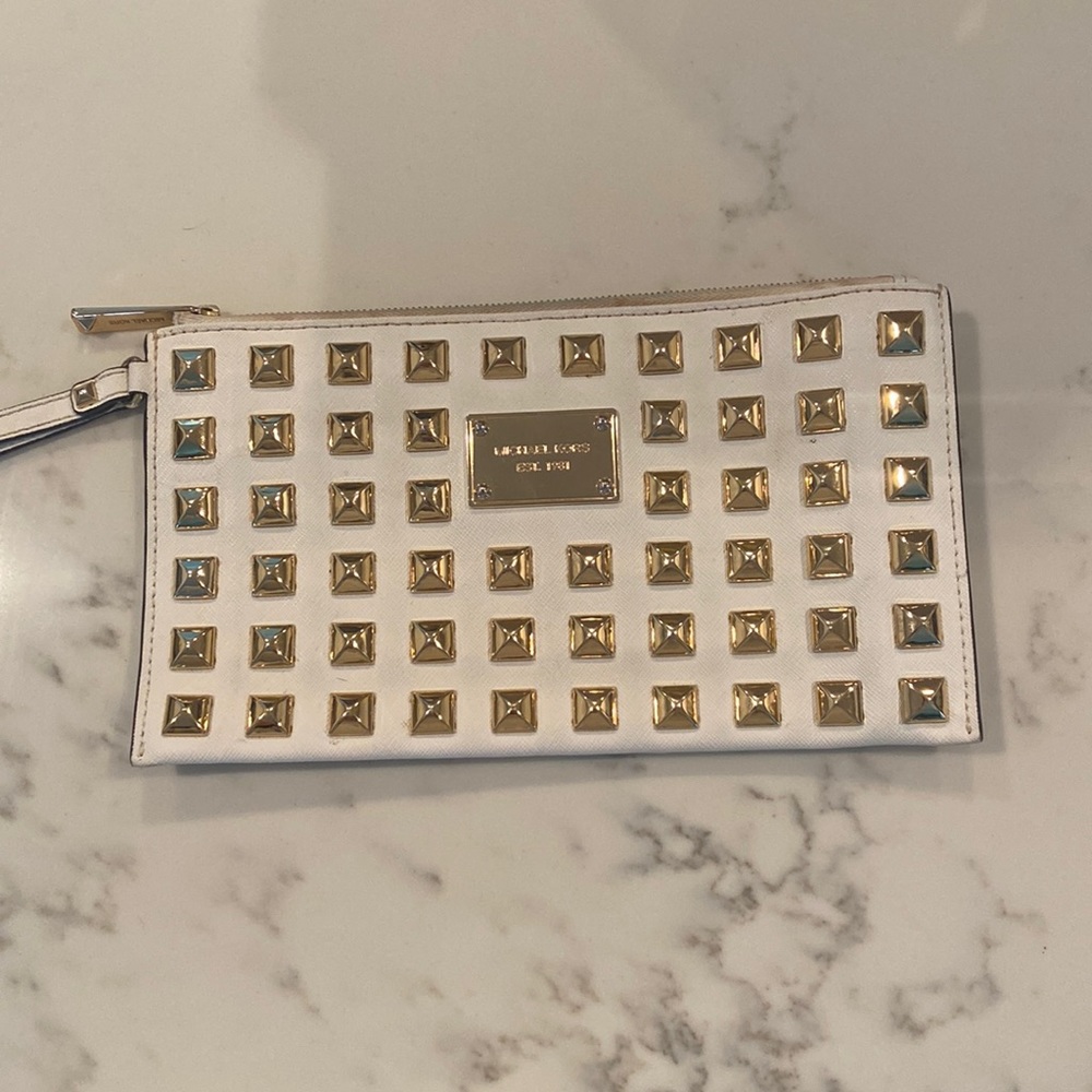 Michael Kors white clutch with gold studs.
